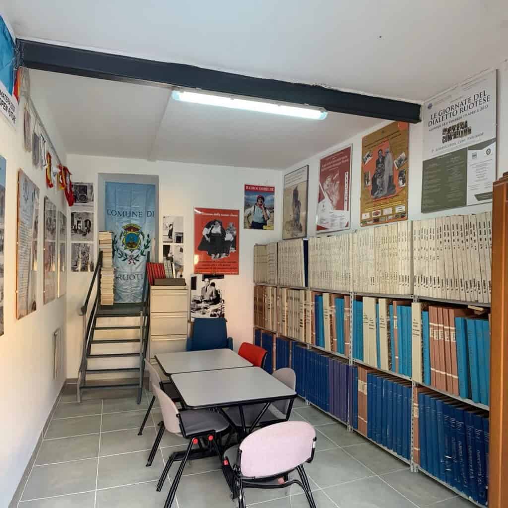 Stanza con libri e manifesti storici.